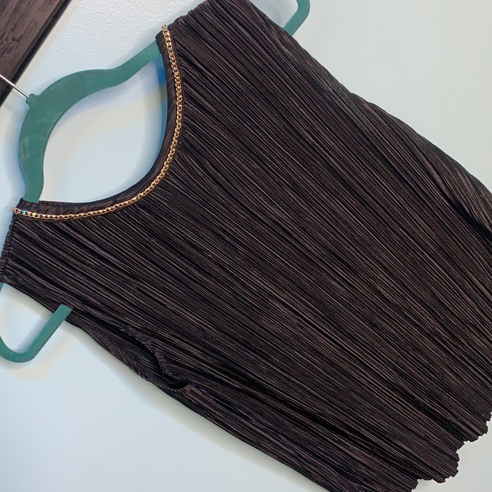 Women’s sleeveless black blouse with gold neck detail